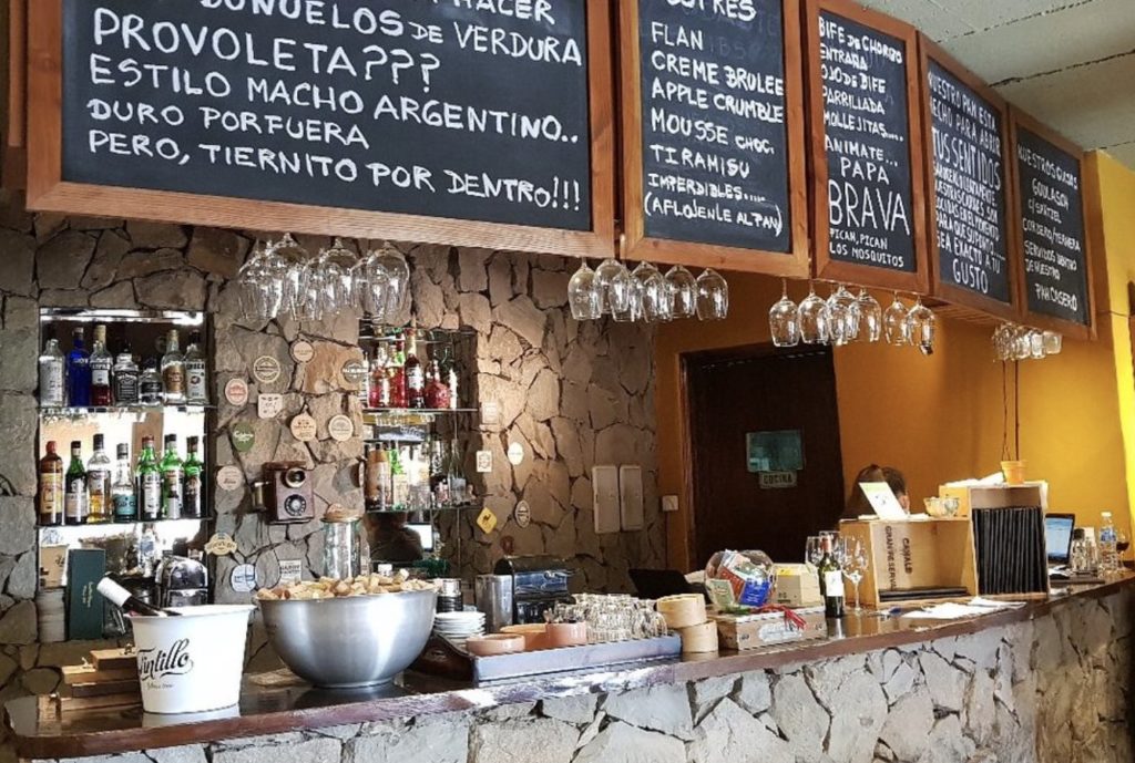 rustic stone bar and chalkboard menus eat in villa la angostura